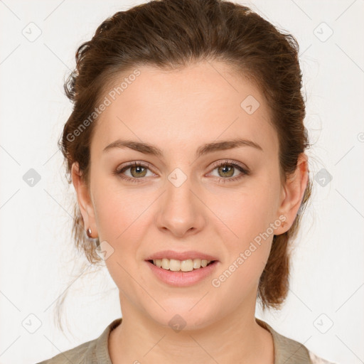 Joyful white young-adult female with medium  brown hair and green eyes