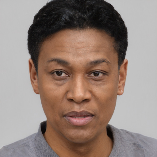 Joyful latino adult male with short  black hair and brown eyes