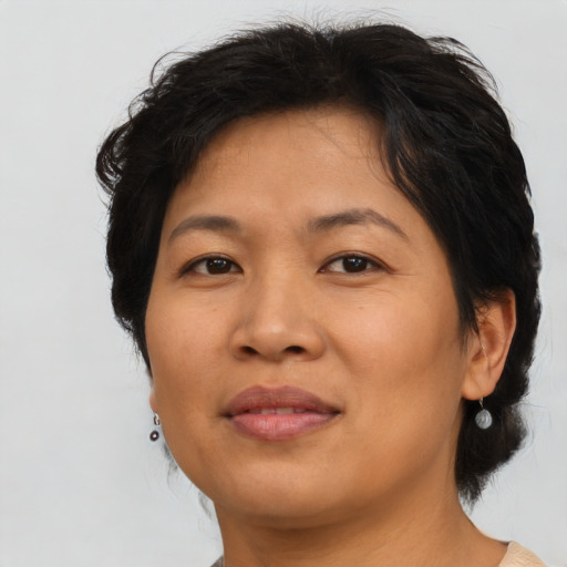 Joyful asian adult female with medium  brown hair and brown eyes