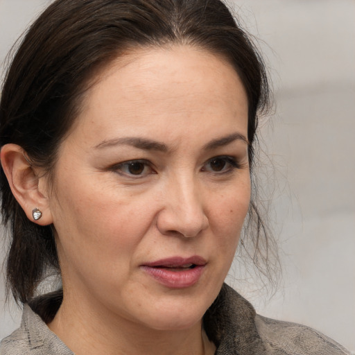 Joyful white adult female with medium  brown hair and brown eyes