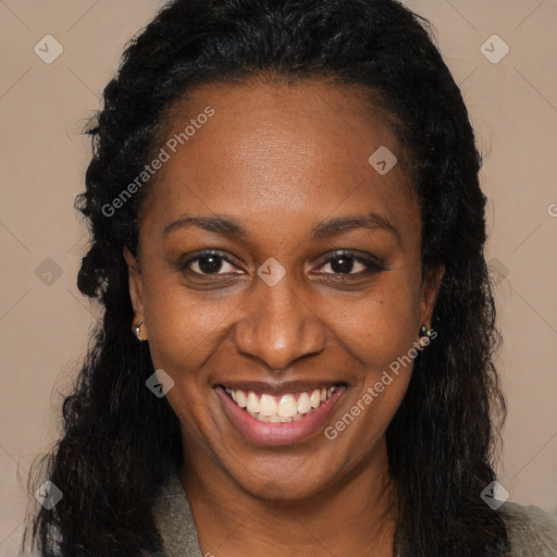 Joyful black young-adult female with long  black hair and brown eyes