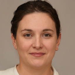 Joyful white adult female with short  brown hair and grey eyes