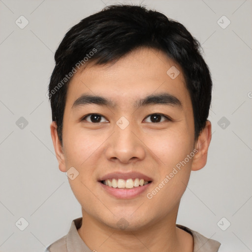 Joyful asian young-adult male with short  black hair and brown eyes