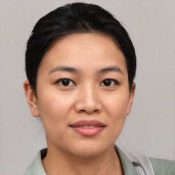 Joyful asian young-adult female with short  brown hair and brown eyes