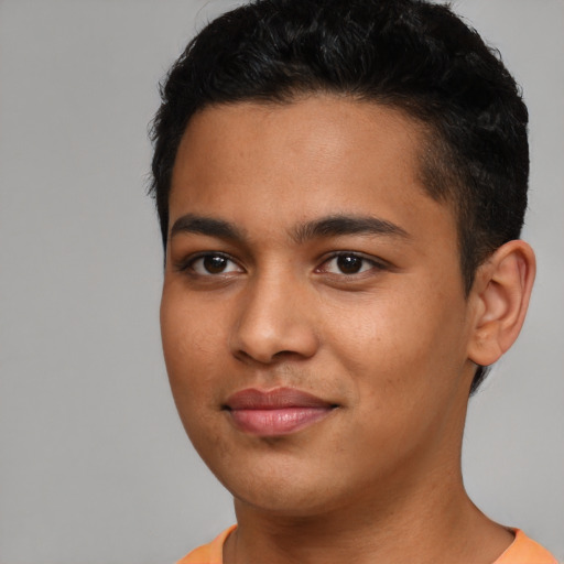 Joyful latino young-adult male with short  brown hair and brown eyes