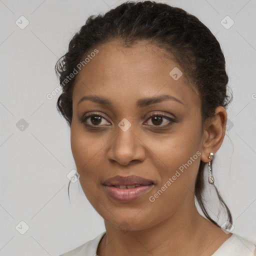 Joyful black young-adult female with short  brown hair and brown eyes