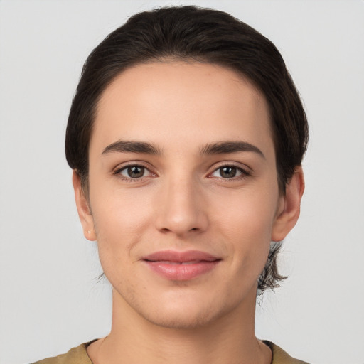 Joyful white young-adult female with short  brown hair and brown eyes