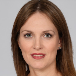 Joyful white adult female with long  brown hair and grey eyes