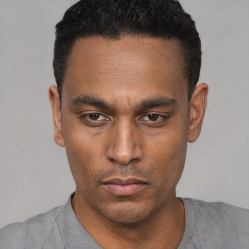 Neutral latino young-adult male with short  black hair and brown eyes