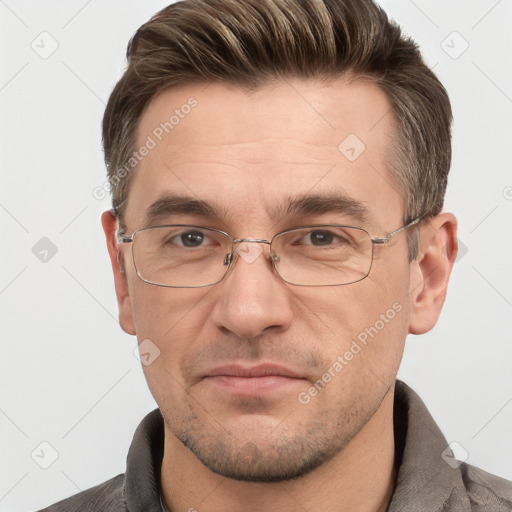 Joyful white adult male with short  brown hair and grey eyes