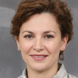 Joyful white adult female with short  brown hair and grey eyes