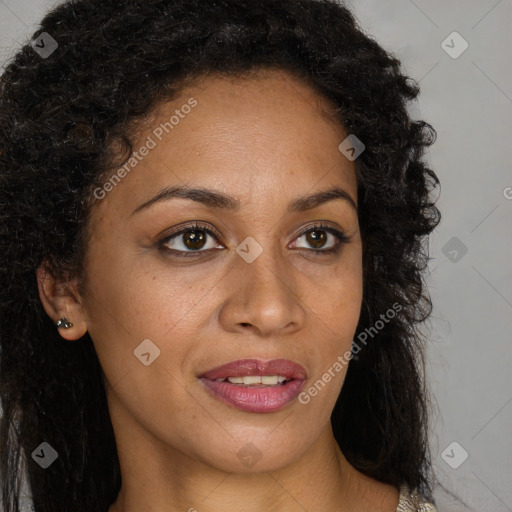 Joyful black young-adult female with long  brown hair and brown eyes