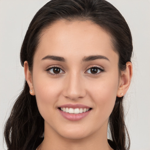 Joyful white young-adult female with long  brown hair and brown eyes