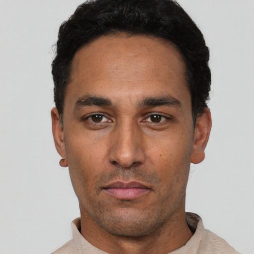 Neutral latino adult male with short  black hair and brown eyes
