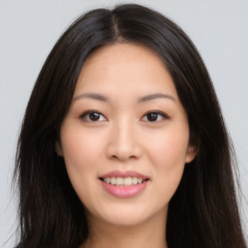 Joyful asian young-adult female with long  brown hair and brown eyes