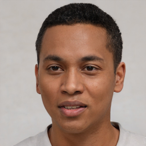 Joyful black young-adult male with short  black hair and brown eyes