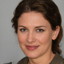 Joyful white adult female with medium  brown hair and brown eyes