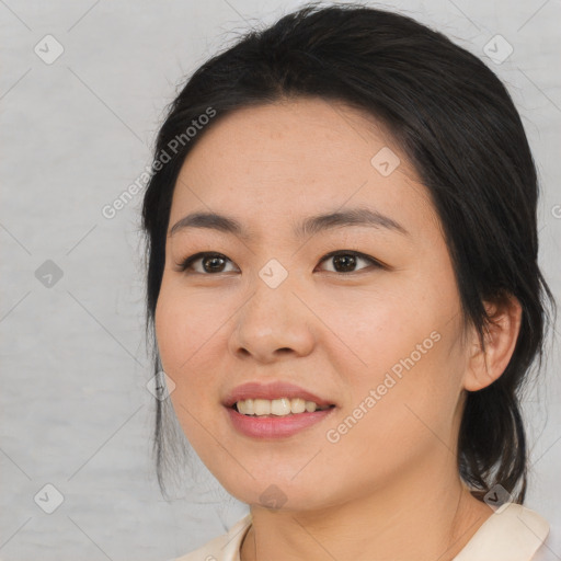 Joyful asian young-adult female with medium  black hair and brown eyes