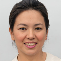 Joyful asian young-adult female with short  brown hair and brown eyes