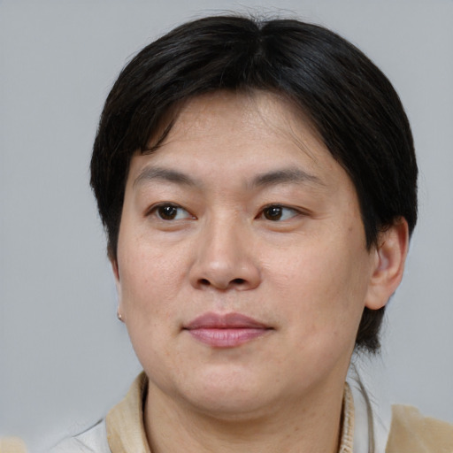 Joyful asian adult female with short  brown hair and brown eyes
