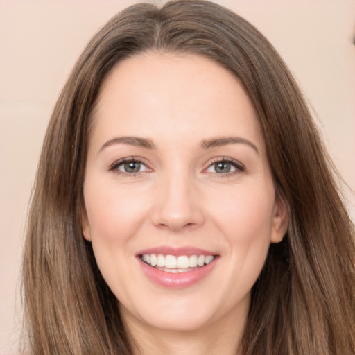 Joyful white young-adult female with long  brown hair and brown eyes