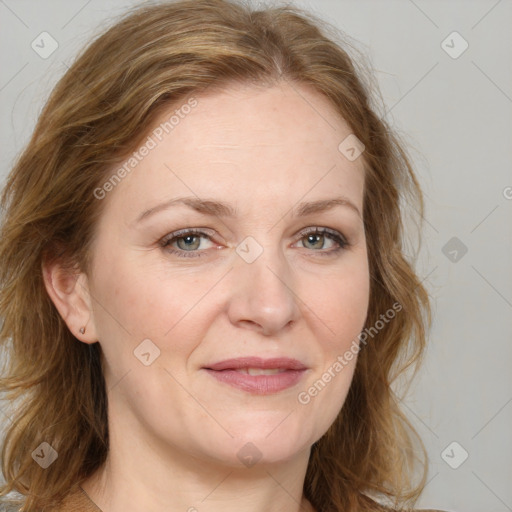 Joyful white adult female with medium  brown hair and blue eyes