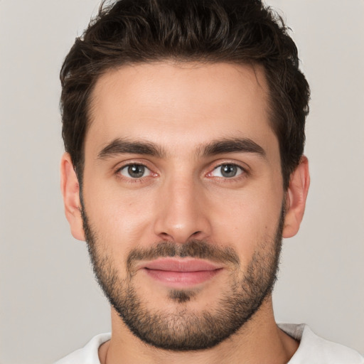 Joyful white young-adult male with short  brown hair and brown eyes