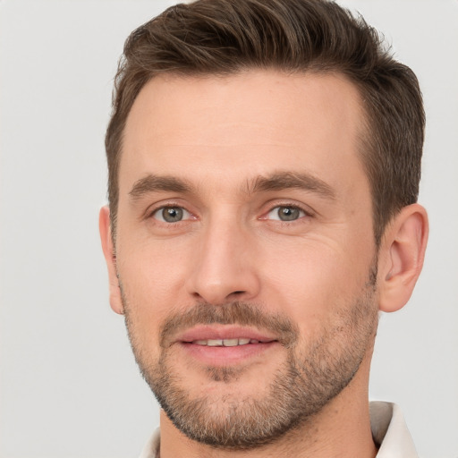 Joyful white adult male with short  brown hair and brown eyes