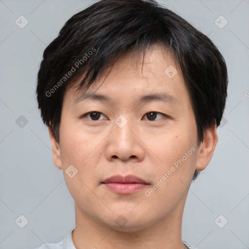 Joyful asian young-adult male with short  brown hair and brown eyes