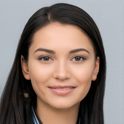 Joyful latino young-adult female with long  brown hair and brown eyes