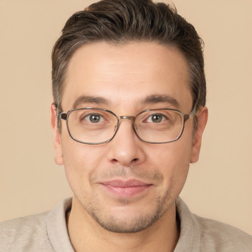 Joyful white adult male with short  brown hair and brown eyes