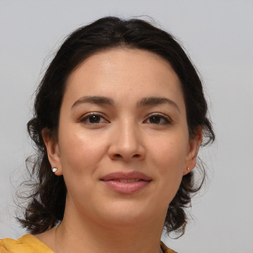 Joyful latino young-adult female with medium  brown hair and brown eyes