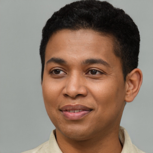 Joyful latino young-adult male with short  brown hair and brown eyes
