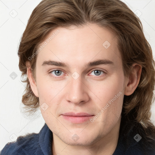 Joyful white young-adult male with medium  brown hair and grey eyes