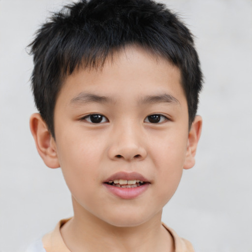 Joyful asian child male with short  brown hair and brown eyes