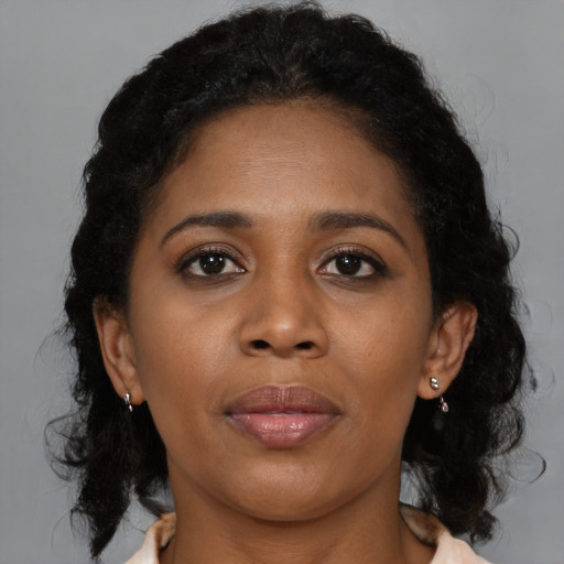 Joyful black young-adult female with medium  brown hair and brown eyes