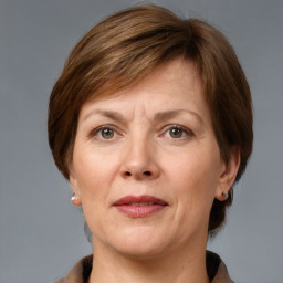 Joyful white adult female with medium  brown hair and grey eyes