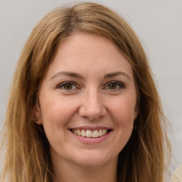 Joyful white young-adult female with long  brown hair and green eyes