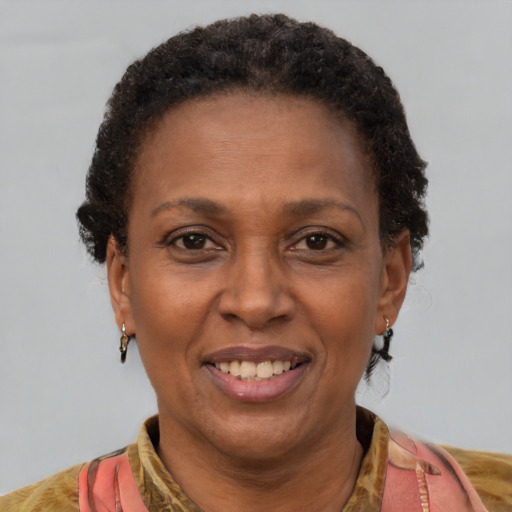 Joyful black adult female with short  brown hair and brown eyes