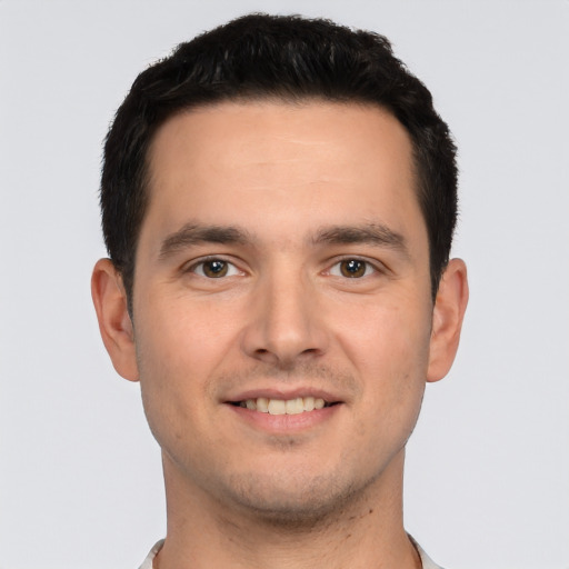 Joyful white young-adult male with short  brown hair and brown eyes