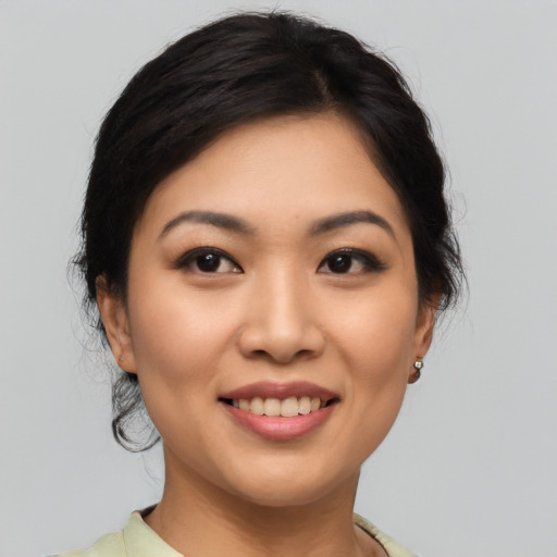 Joyful asian young-adult female with medium  brown hair and brown eyes