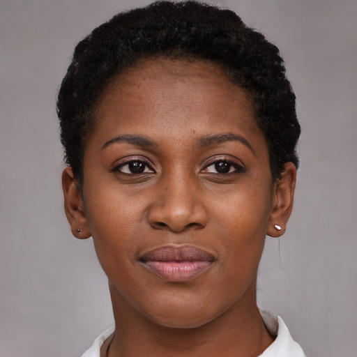 Joyful black young-adult female with short  brown hair and brown eyes