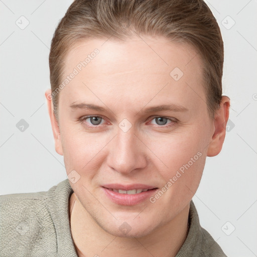 Joyful white young-adult female with short  brown hair and blue eyes