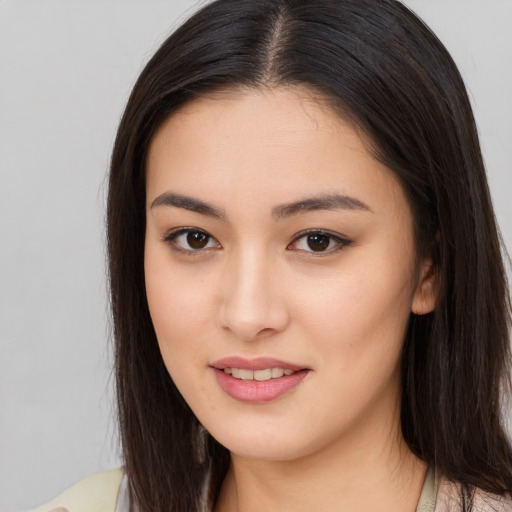 Joyful asian young-adult female with long  brown hair and brown eyes