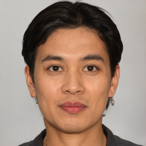 Joyful white young-adult male with short  black hair and brown eyes