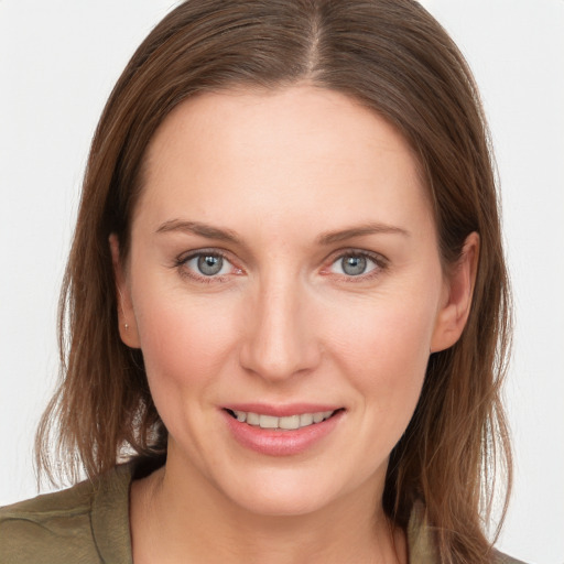 Joyful white young-adult female with long  brown hair and grey eyes