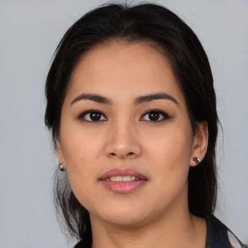 Joyful latino young-adult female with long  brown hair and brown eyes
