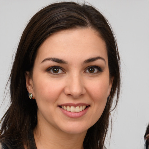 Joyful white young-adult female with long  brown hair and brown eyes