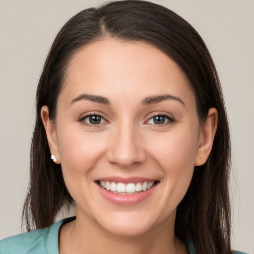 Joyful white young-adult female with long  brown hair and brown eyes