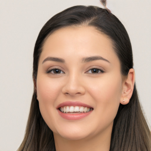 Joyful white young-adult female with long  black hair and brown eyes